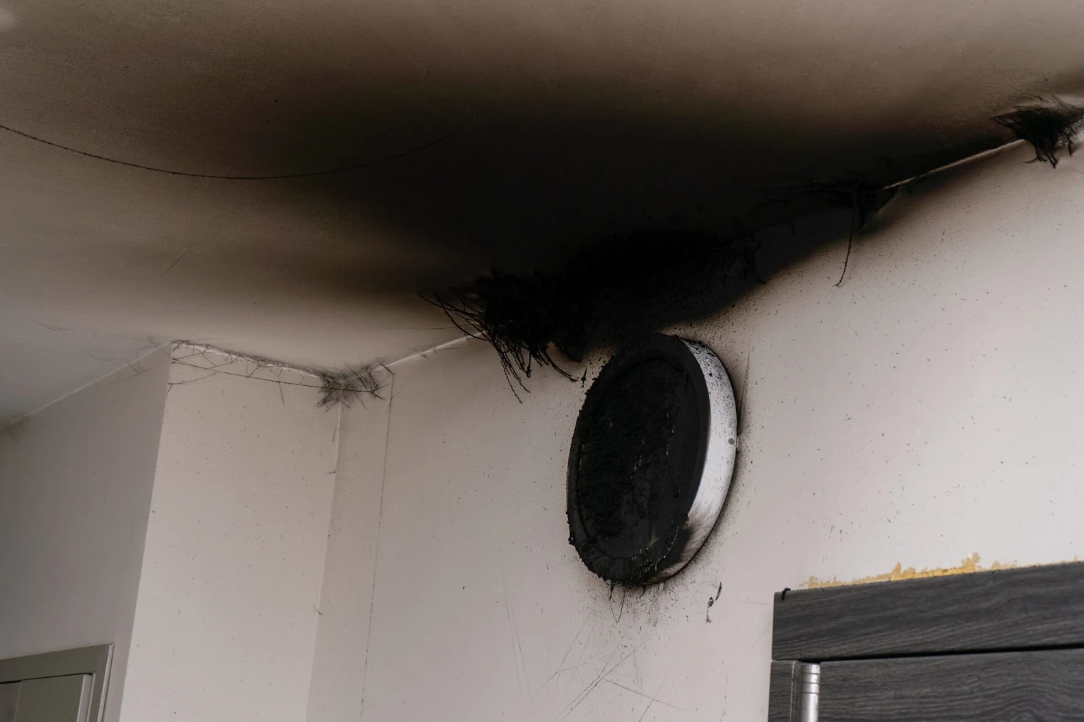 Smoke and soot damage on interior wall.